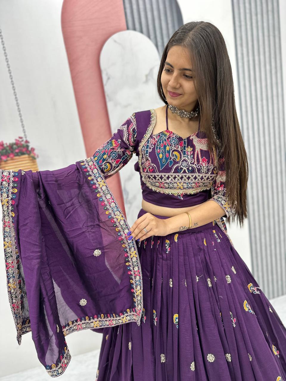 Woman wearing a purple traditional outfit with colorful patterns