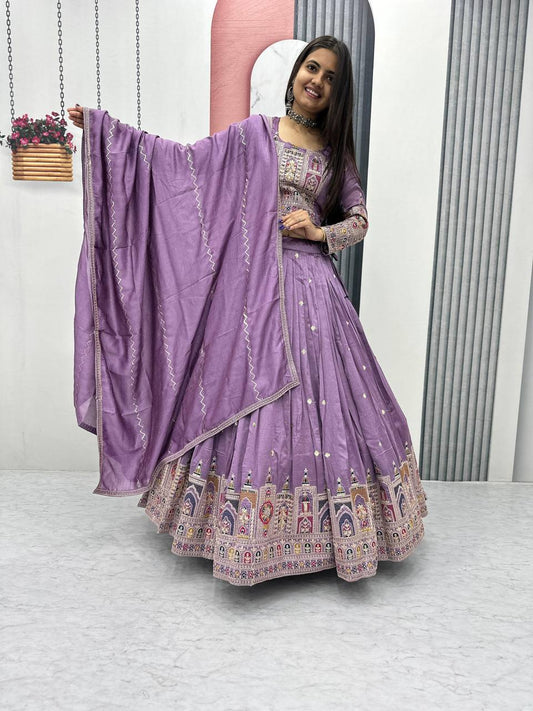 Woman in a purple traditional outfit with a matching dupatta.