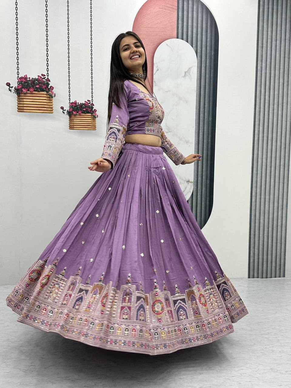 Woman in a purple embroidered traditional outfit Lehenga Choli