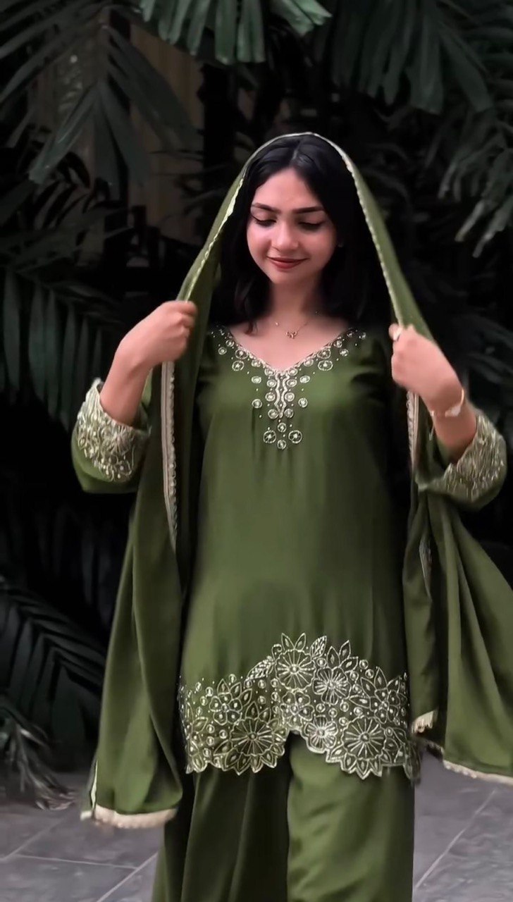 Woman wearing a green traditional outfit with embroidery Work