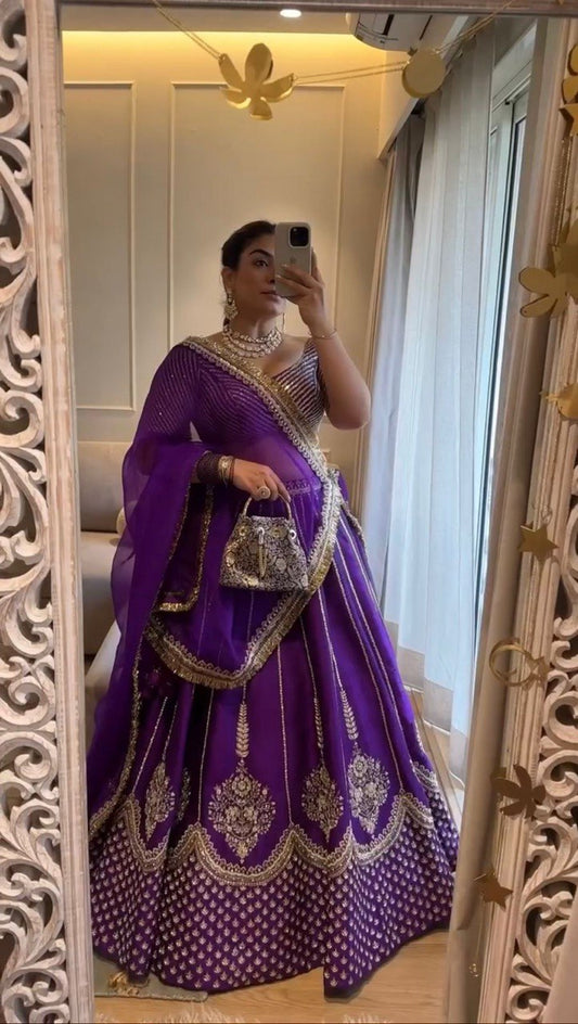 Person wearing a purple Lehenga with gold Sequence Work 